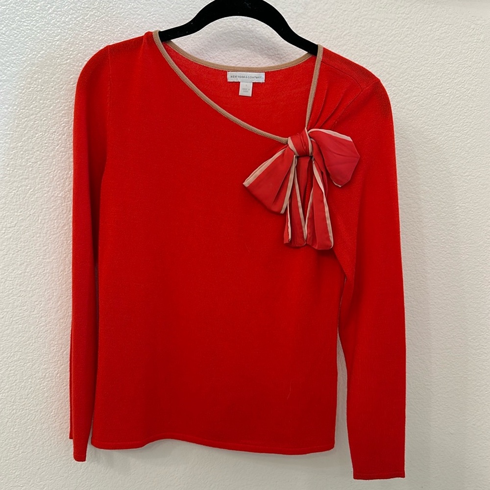 Red sweater with bow details